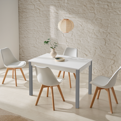 Mesa blanca con patas grises y sillas blancas