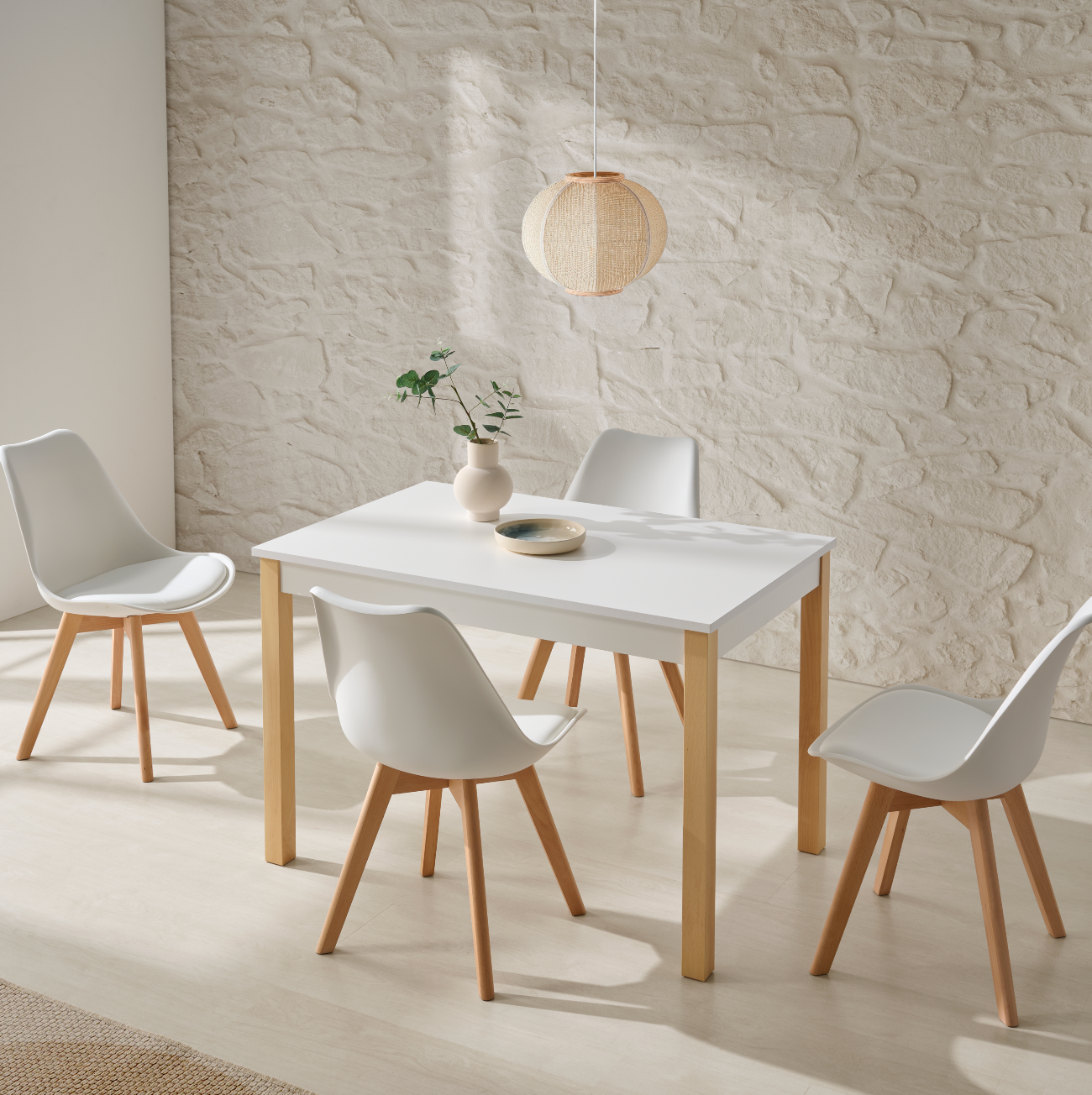 Mesa blanca nórdica con patas de madera y sillas a juego