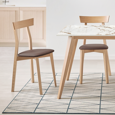 Mesa de comedor de madera y encimera dekton con sillas de madera a juego